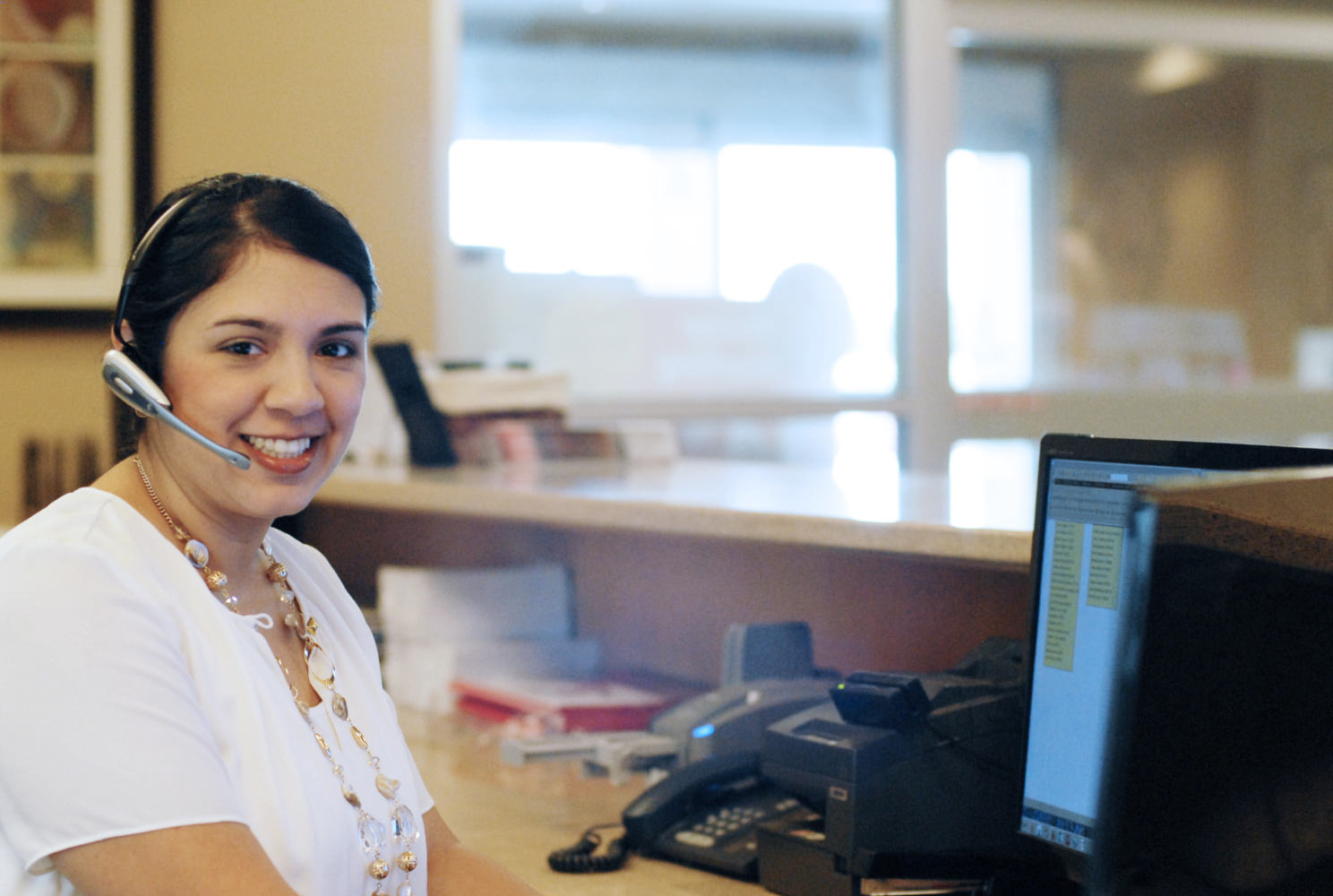 a smiling gvec customer service representative wearing a headset and how to talk to a customer service representative