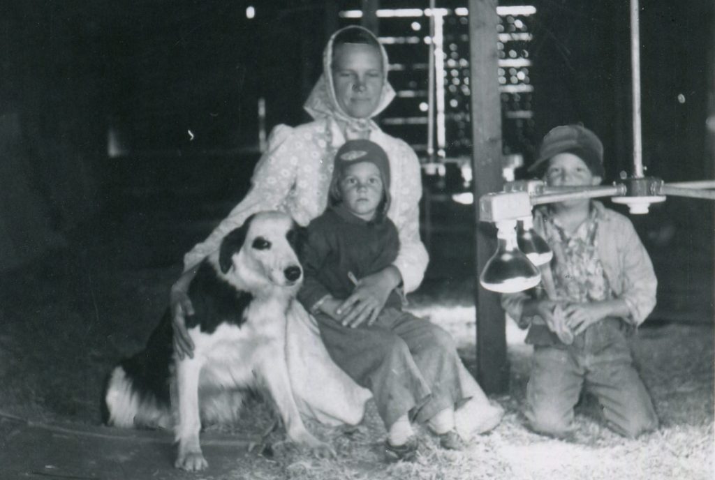 Mom, kids, and dog in barn