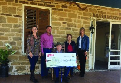 A pic of Polley Mansion owners accepting a check from GVEC