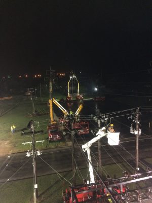 GVEC linemen in bucket trucks at night
