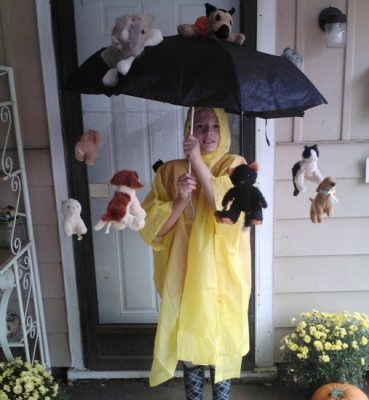 Picture of a young boy dressed in a yellow rain slicker and a cats and dogs storm-brella special Homemade Halloween Costume
