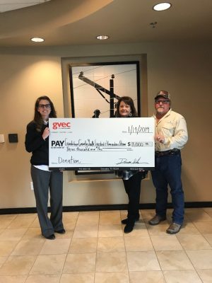 From left: Kasie Tankersley, community relations representative with the Guadalupe Valley Electric Cooperative (GVEC), presents a $3,000 donation to Charla Bading and Travis Franke of the Guadalupe County Youth Livestock and Homemakers Show, Guadalupe Valley Livestock Shows