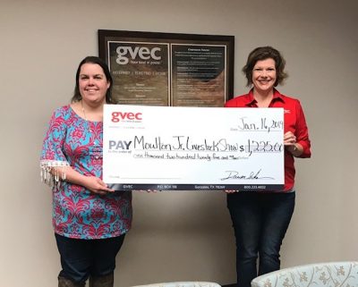 Mallory Haas, FFA advisor for the Moulton Jr. Livestock Show, receives a $1,225.00 donation from Christine Presley, Guadalupe Valley Livestock Shows, education in the Guadalupe Valley