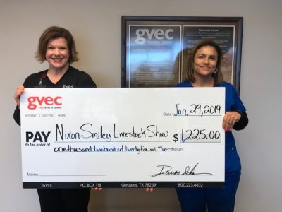 From left: Christine Presley, community relations representative with the Guadalupe Valley Electric Cooperative (GVEC), presents a $1,225.00 donation to Sheila Mendiola, secretary with the 2019 Nixon-Smiley Livestock Show, education in the Guadalupe Valley
