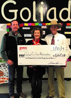 Center: Christine Presley, community relations representative from the Guadalupe Valley Electric Cooperative (GVEC), presents a $1,225.00 donation to Brian Yanta, Advisor, and Roy Boyd, Chairperson for the 2019 Goliad Co. Fair Association, Guadalupe Valley Livestock Shows
