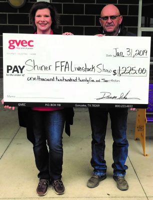 Christine Presley, community relations representative with the Guadalupe Valley Electric Cooperative (GVEC), presents a $1,225.00 donation to Bruce Pohler, FFA sponsor with the 2019 Shiner FFA Livestock Show, agriculture in the Guadalupe Valley