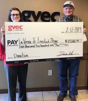 From left: Kasie Tankersley, community relations representative from the Guadalupe Valley Electric Cooperative (GVEC), presents a $2,500 donation to Mark Koepp of the 2019 La Vernia Junior Livestock Show, Guadalupe Valley Livestock Shows