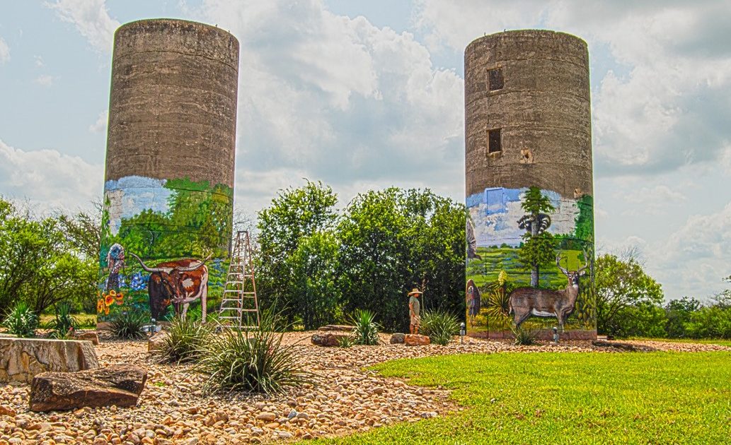 Wide shot of two towers with rafael acosta mural paintings