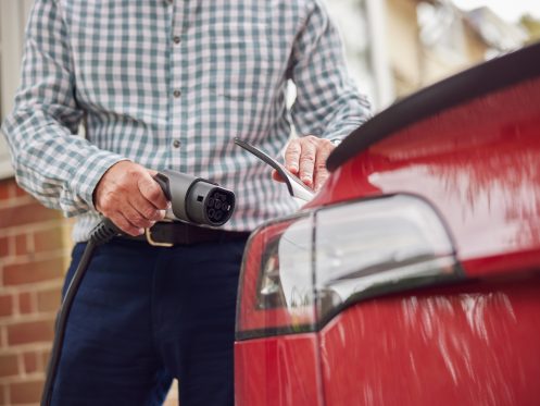 Man who has decided to drive electric plugging into his home charger