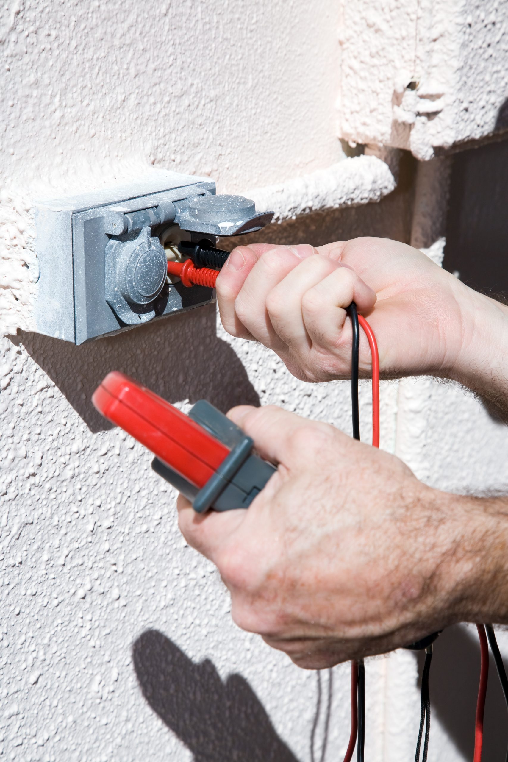 electrician checking voltage for home wiring inspections