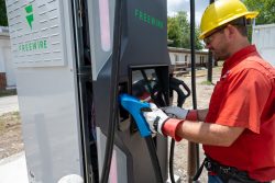 A gvec worker with an EV charger