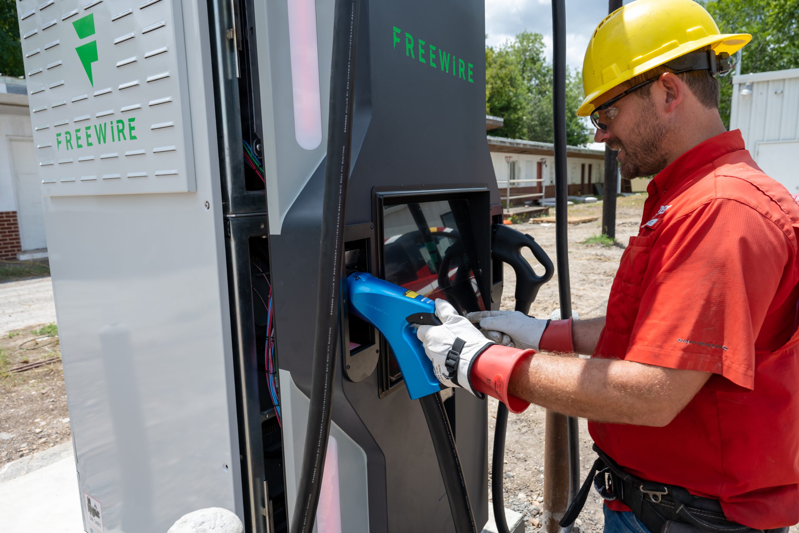 A gvec worker with an EV charger
