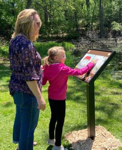 Woman and child reading outdoors